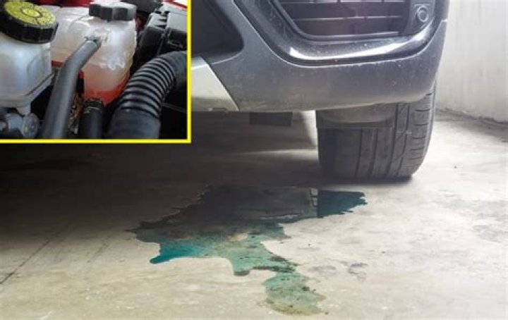 Coolant pouring out of bottom of car
